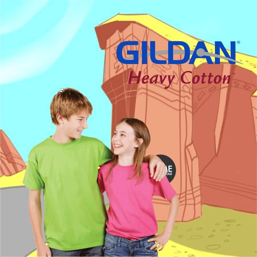 5000b Two children wearing Gildan Heavy Cotton t-shirts, one in bright green and the other in vibrant pink, standing smiling with a cartoon-style background.
