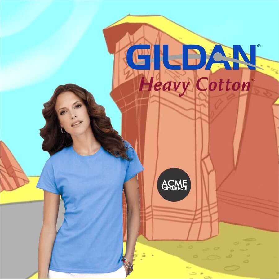 Woman wearing a light blue Gildan Heavy Cotton T-shirt against a cartoon desert rock background