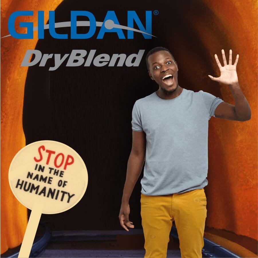 Happy man wearing a light blue Gildan DryBlend t-shirt and mustard yellow pants, smiling and waving against a dark orange background with a sign reading 'Stop In The Name Of Humanity'