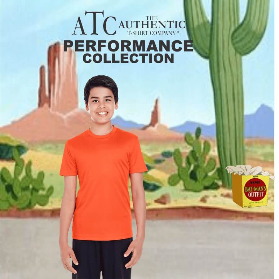 Y350 Boy wearing bright orange short-sleeve performance t-shirt standing in front of a desert landscape background with cacti and rock formations