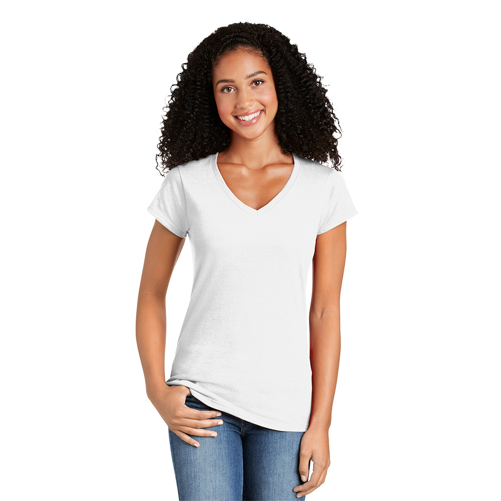 Young woman with curly dark hair wearing a white V-neck T-shirt and blue jeans, smiling with one hand resting in her jeans pocket and the other hanging by her side against a white background