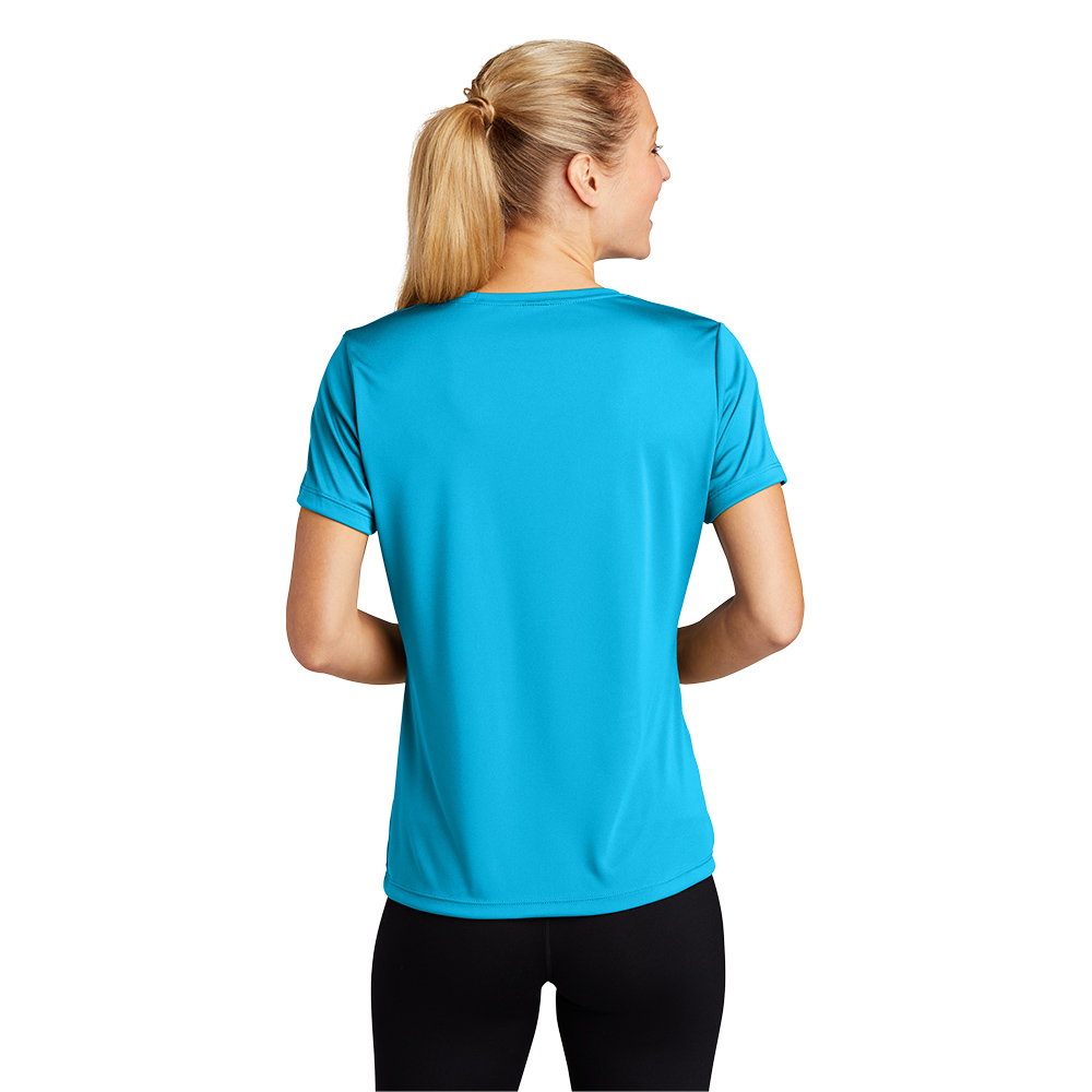 Rear view of a woman with blonde hair in a ponytail wearing a plain bright blue short-sleeve athletic shirt and black leggings against a white background