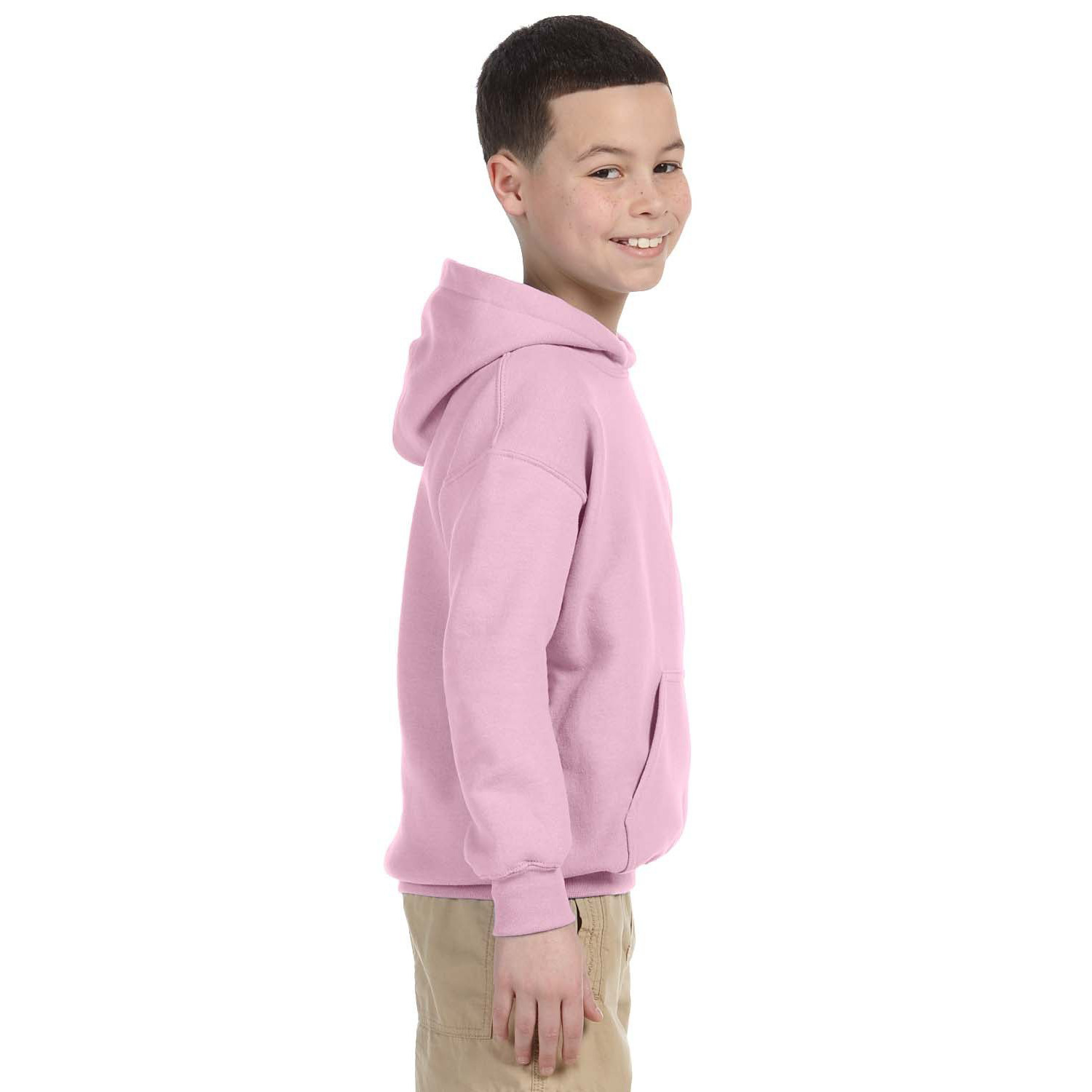 18500B_cover_side Smiling boy with short hair wearing a light pink hoodie and beige pants, standing sideways against a white background.