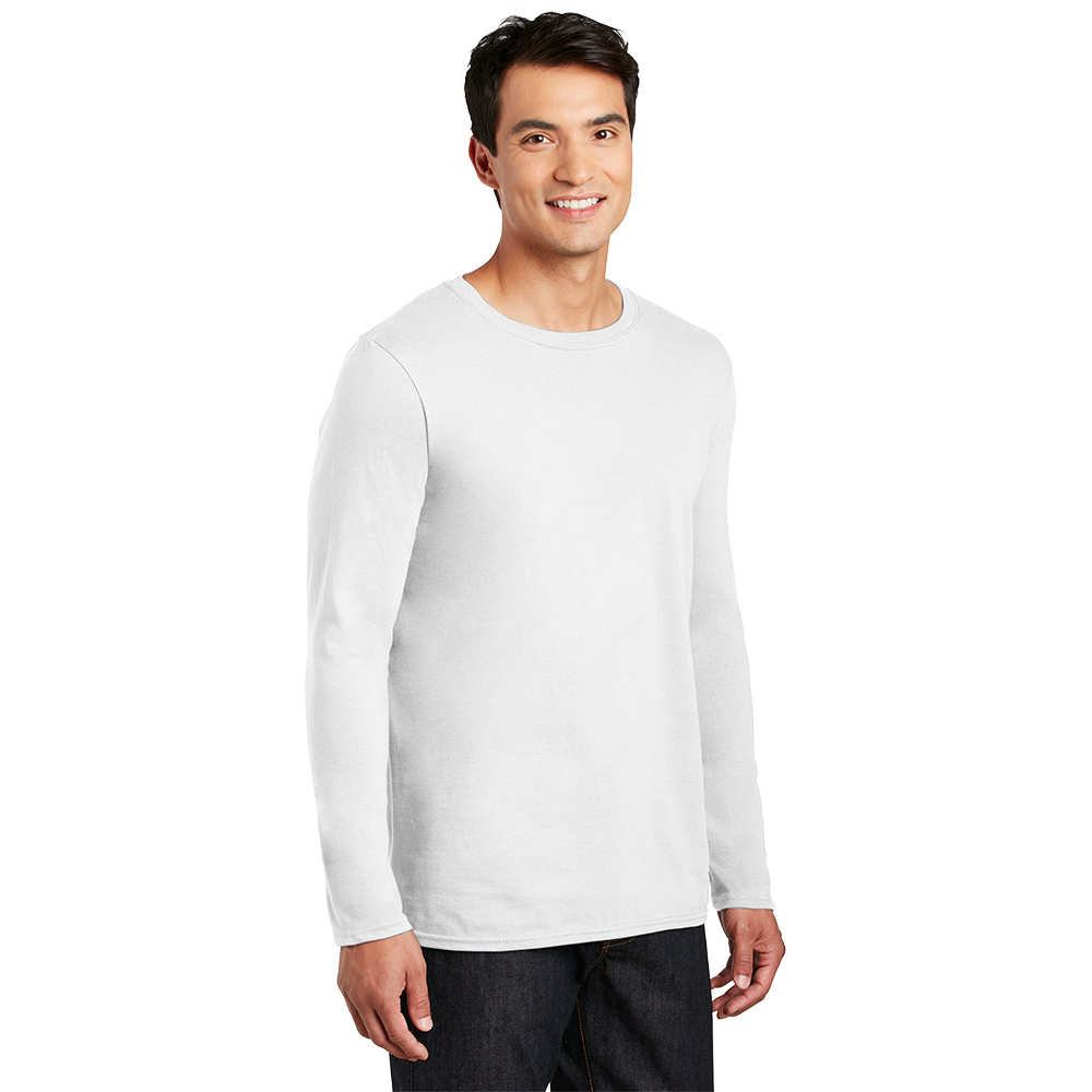 Model wearing a white long-sleeve t-shirt paired with dark jeans, smiling and posing in a casual setting. Ideal for showcasing comfortable and stylish men's apparel.