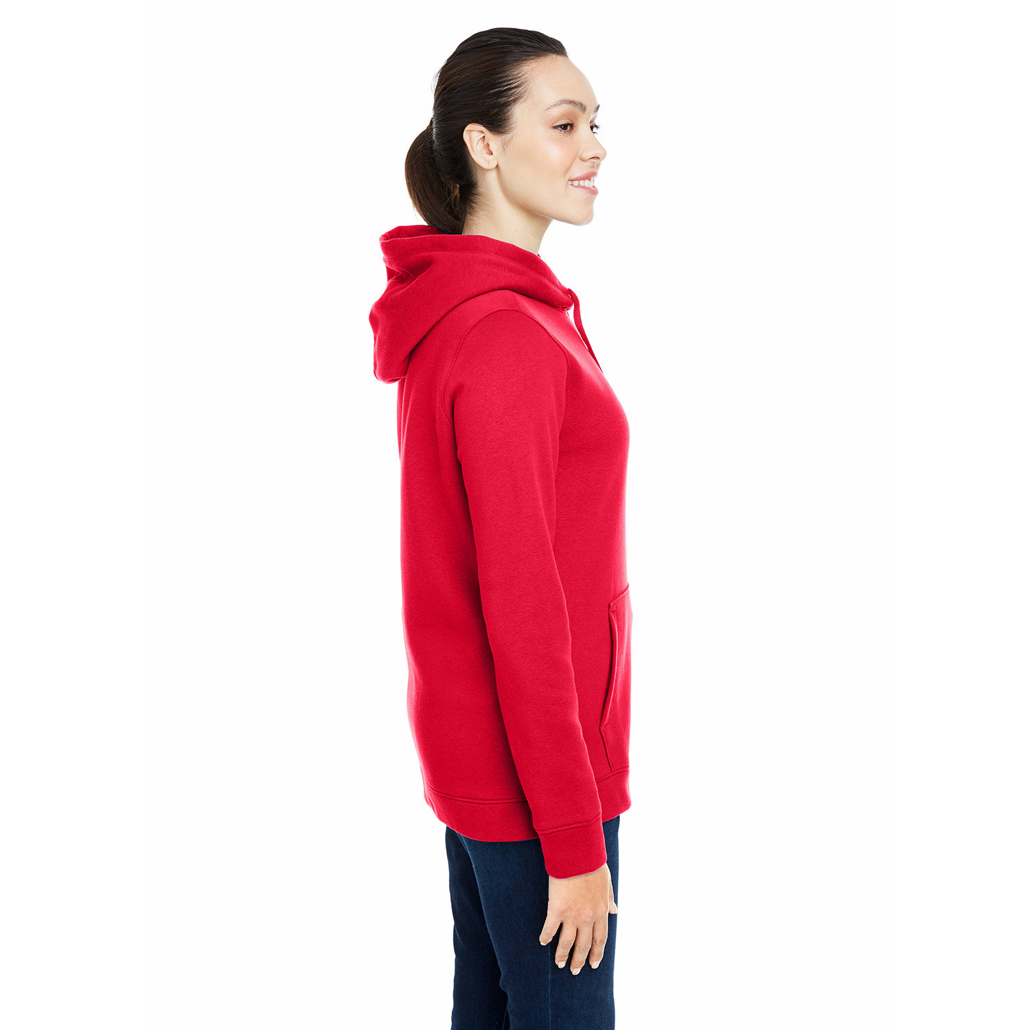 ua_ladies_cover_hustle_hoodie_side Side profile of a smiling woman with dark hair in a ponytail wearing a red hooded sweatshirt and dark pants against a white background