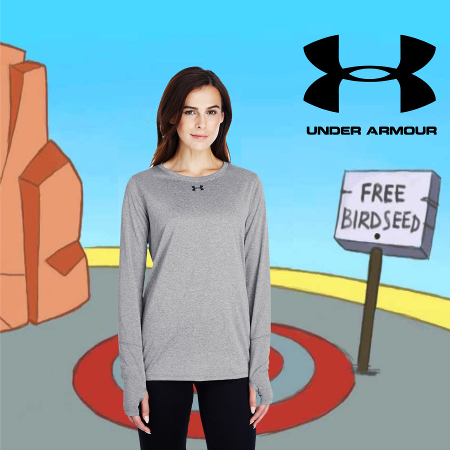 Woman wearing a gray Under Armour long-sleeve shirt standing in front of a cartoon background featuring red rock formations, a yellow and gray circular ground, a polarized sign saying 'FREE BIRDSEED,' and a large black Under Armour logo with text in the top right corner.
