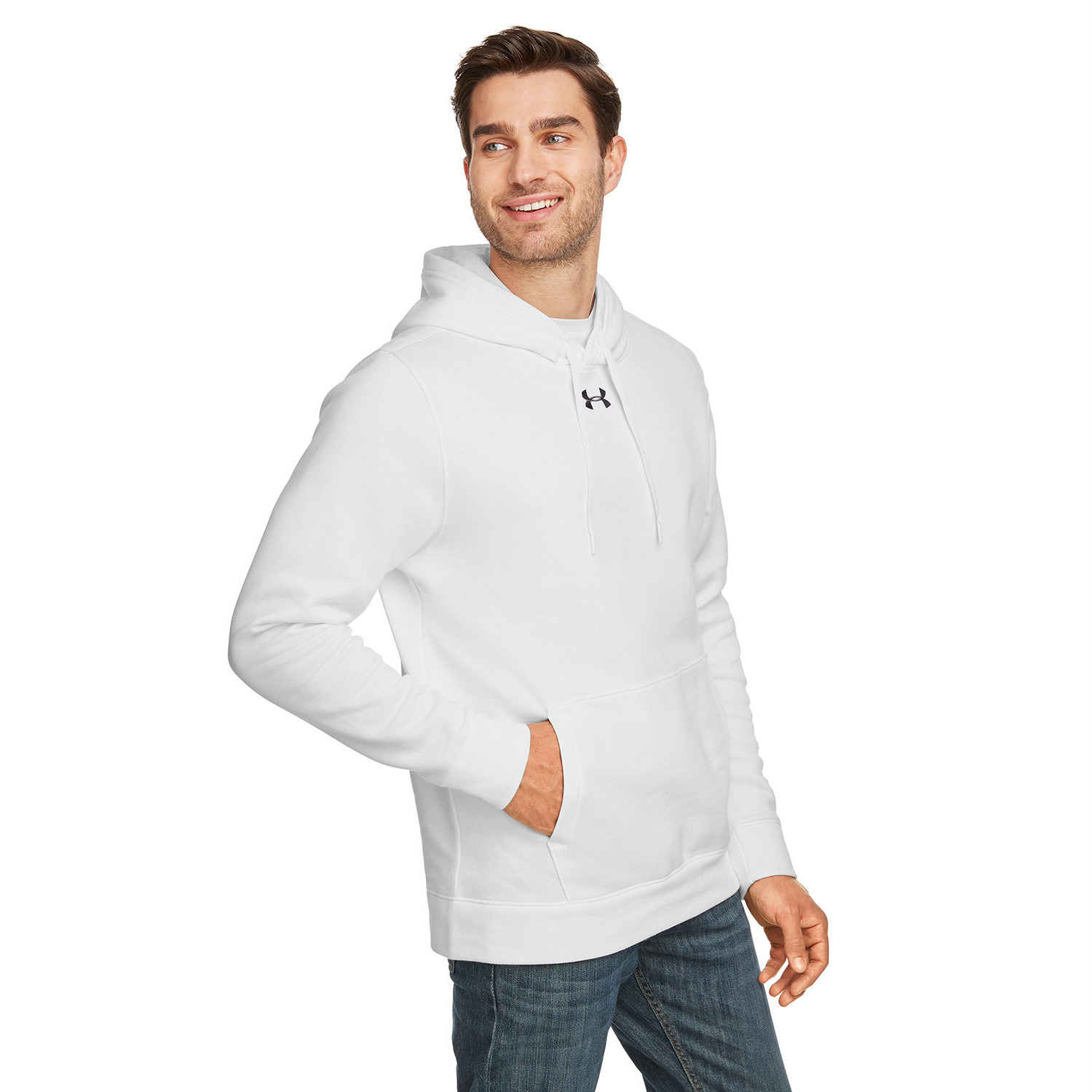 Man wearing a white Under Armour hoodie with a front pocket and drawstrings, paired with blue jeans, looking to the side and smiling.