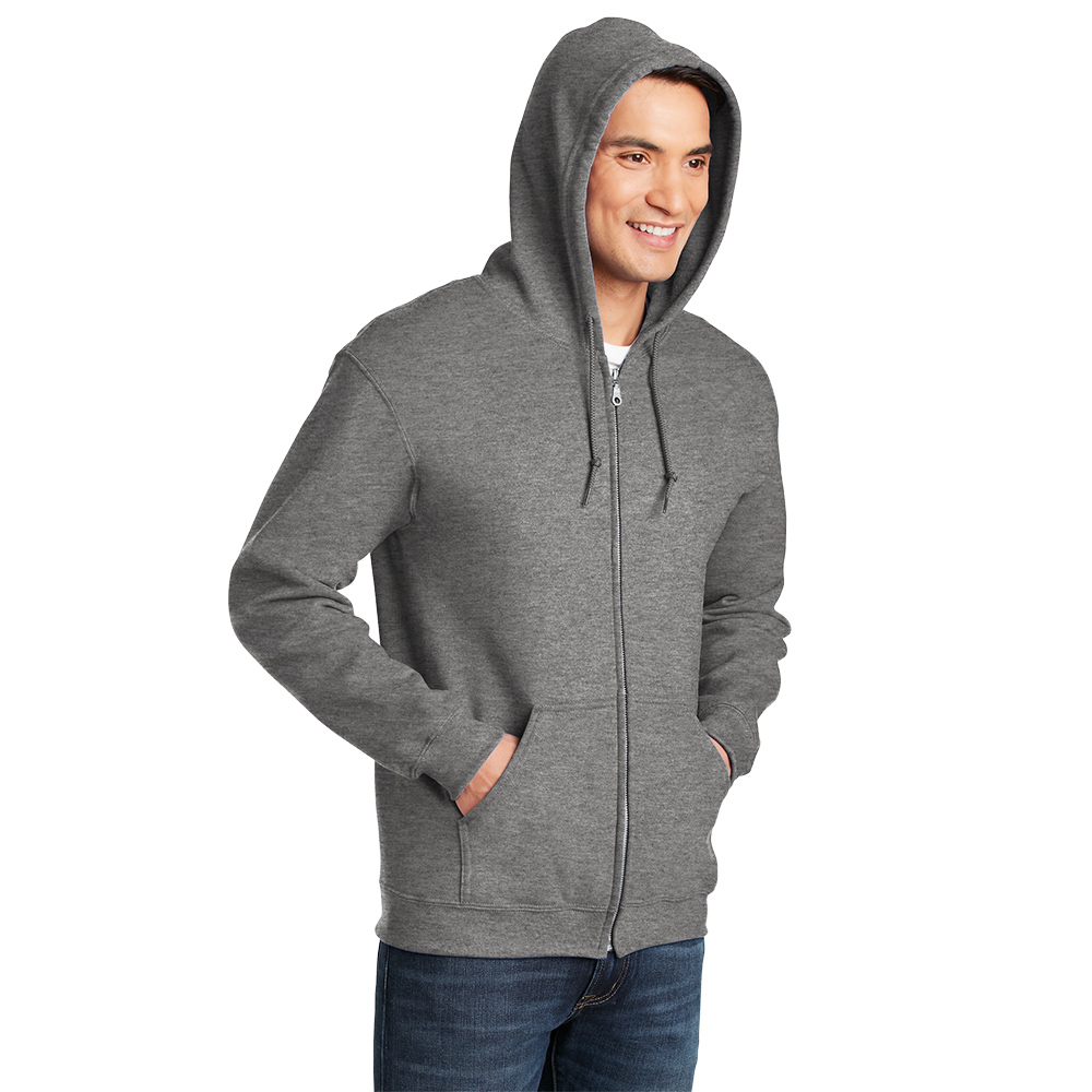 18600_graphiteheather_model_hood Man wearing a gray zip-up hoodie with the hood up, hands in pockets, and blue jeans, smiling and looking to the side against a white background