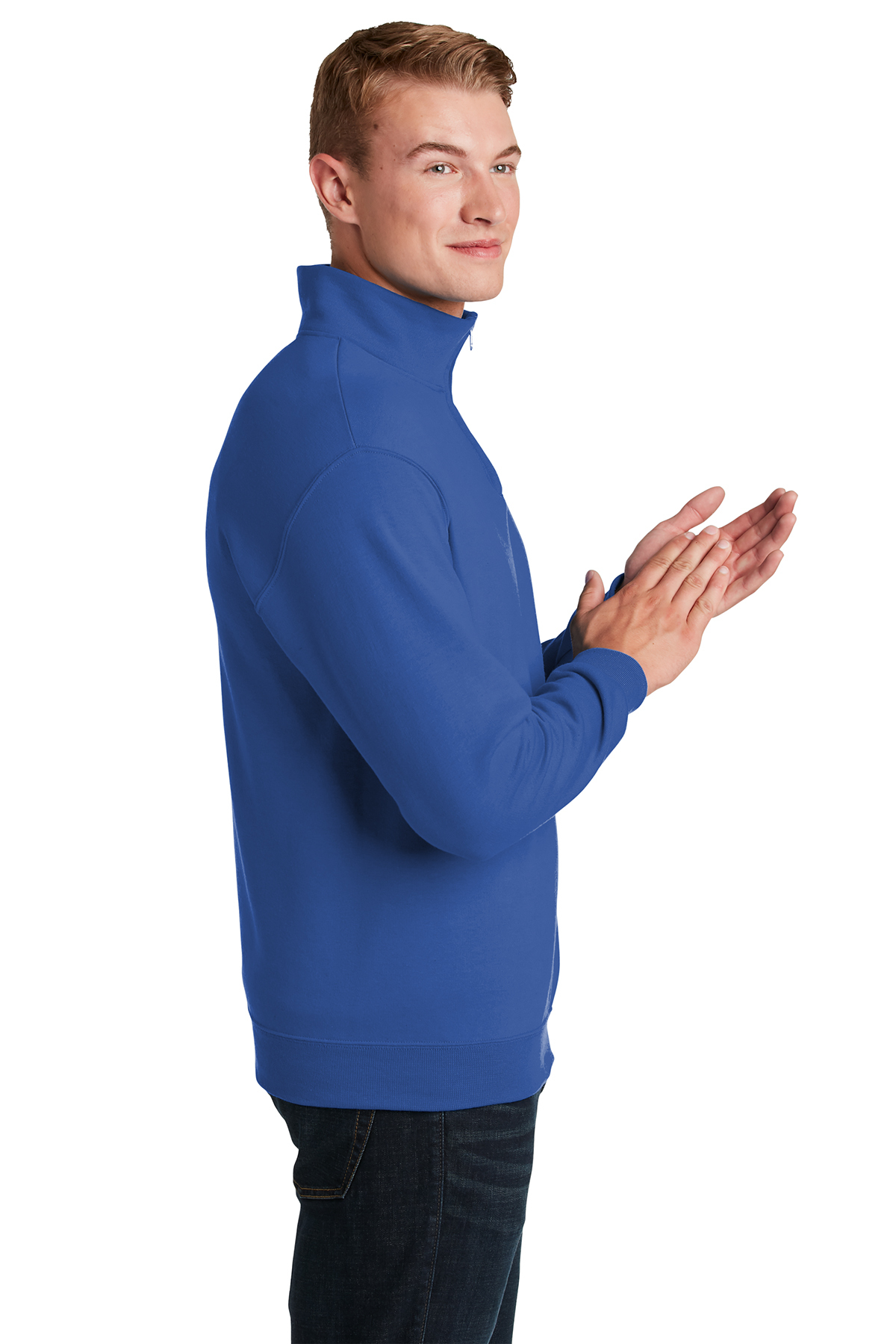 5120-Royal-3-995MRoyalModelSide1-1200W Man wearing a blue zip-up sweatshirt with a high collar, standing in a side profile and clapping his hands. The outfit is paired with dark jeans, showcasing a casual and stylish look suitable for everyday wear.