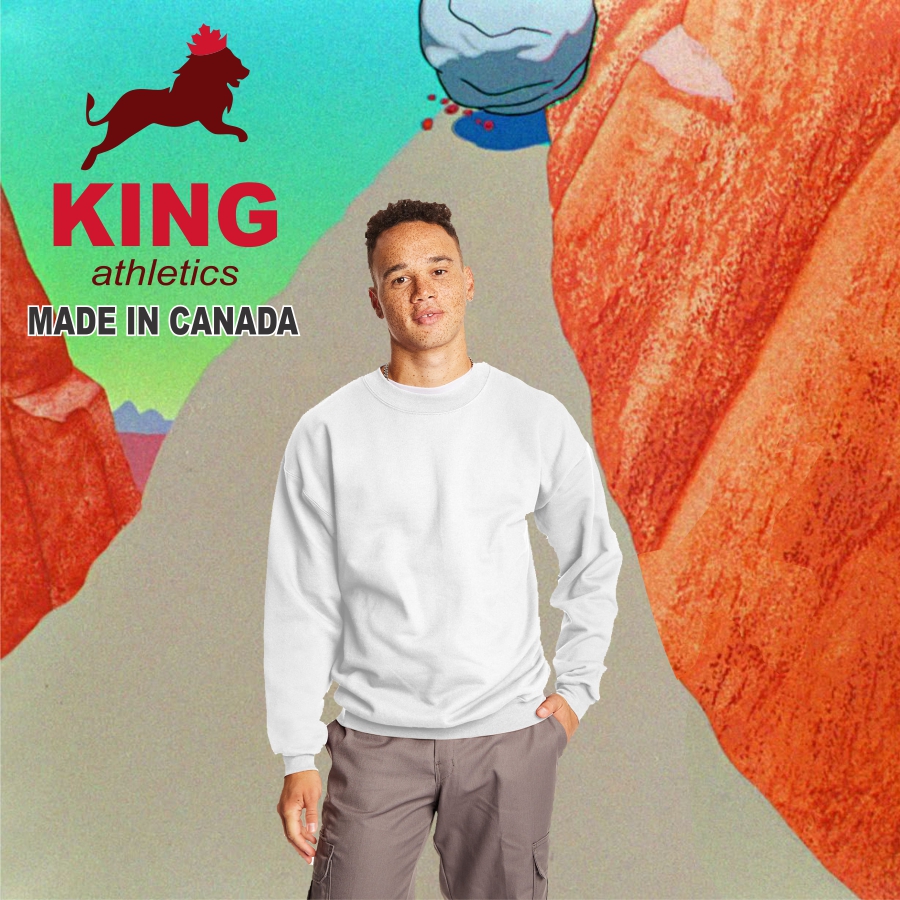 A man wearing a plain white sweatshirt and gray pants stands with one hand in his pocket against a colorful abstract background with red and orange rock formations; text in the upper left reads 'KING athletics MADE IN CANADA' alongside a red silhouette of a lion with a maple leaf crown.
