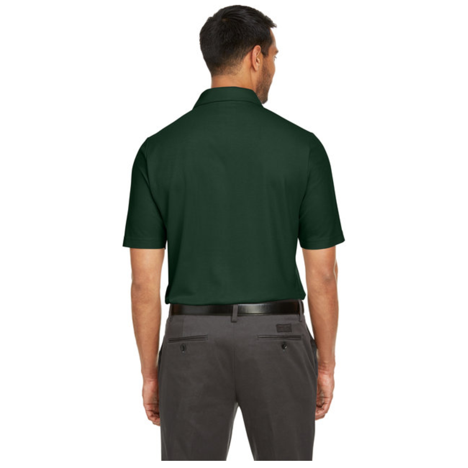 Rear view of a man wearing a dark green short-sleeve polo shirt tucked into dark gray dress pants with a black belt against a white background.