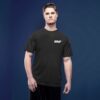 mnp_attain_cover_5 Man wearing a black t-shirt with short sleeves and white text that reads 'MNP' on the left chest, standing against a plain dark blue background.