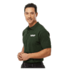 mnp_mens_polo_cover Man wearing a dark green polo shirt with the white MNP logo on the chest, standing with hands clasped and smiling slightly.