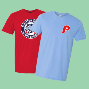Red and blue t-shirts featuring baseball team logos, including Kingston Jr. Ponies Baseball and a stylized Philadelphia Phillies emblem, displayed against a light green background.